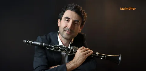 Blagoj Lamjov som håller i en oboe framför en svart bakgrund