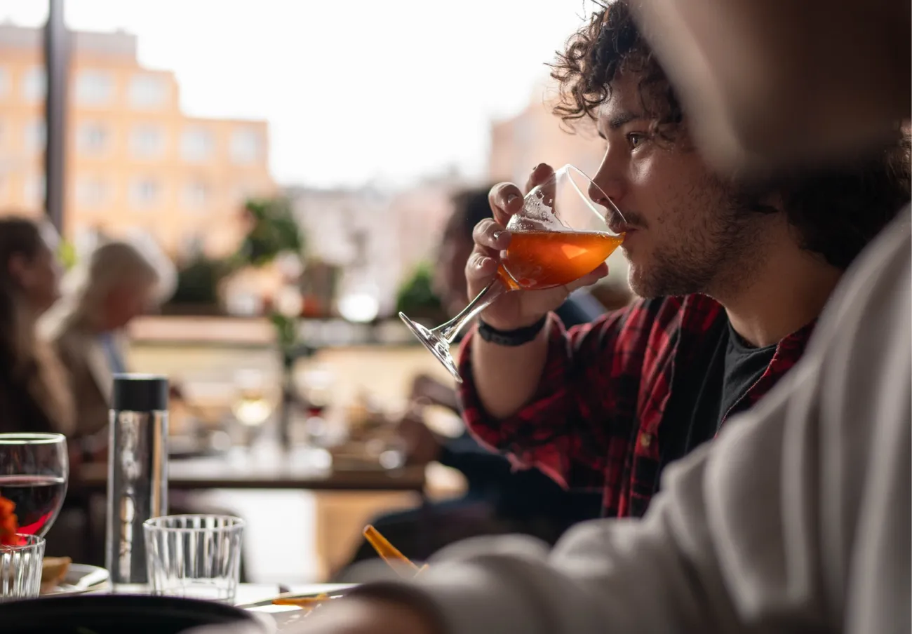 Young man enjoys a drink during the interval at Malmö Live Concert Hall